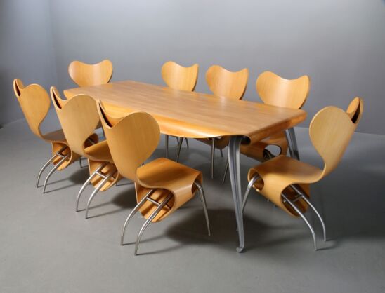 8 Empty Chairs and Fly Ply table in birch with a cast aluminum frame.
